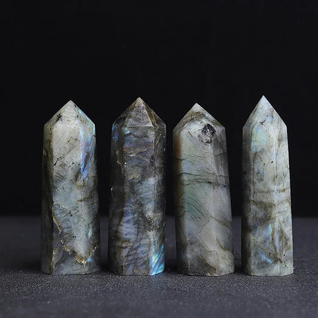 Four crystal points on a dark background
