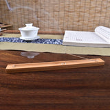 Wooden incense burner on a wooden table with a blurred background