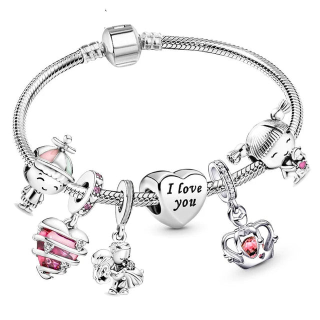 Silver bracelet with various charms including hearts and animals on a white background