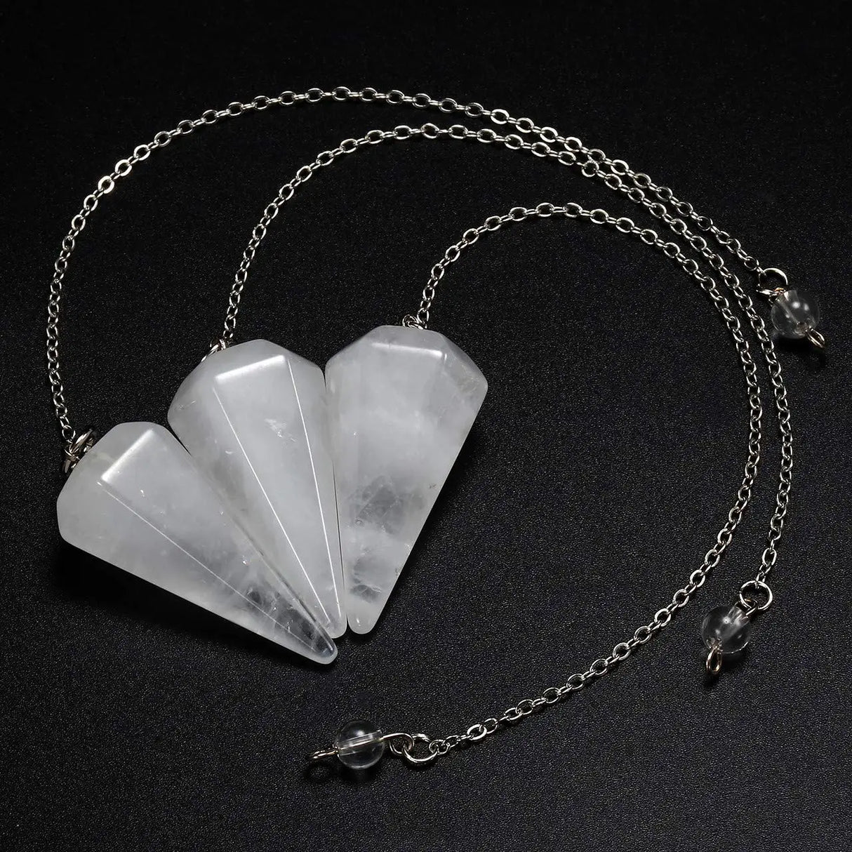 Necklace with five stone pendants on a black background