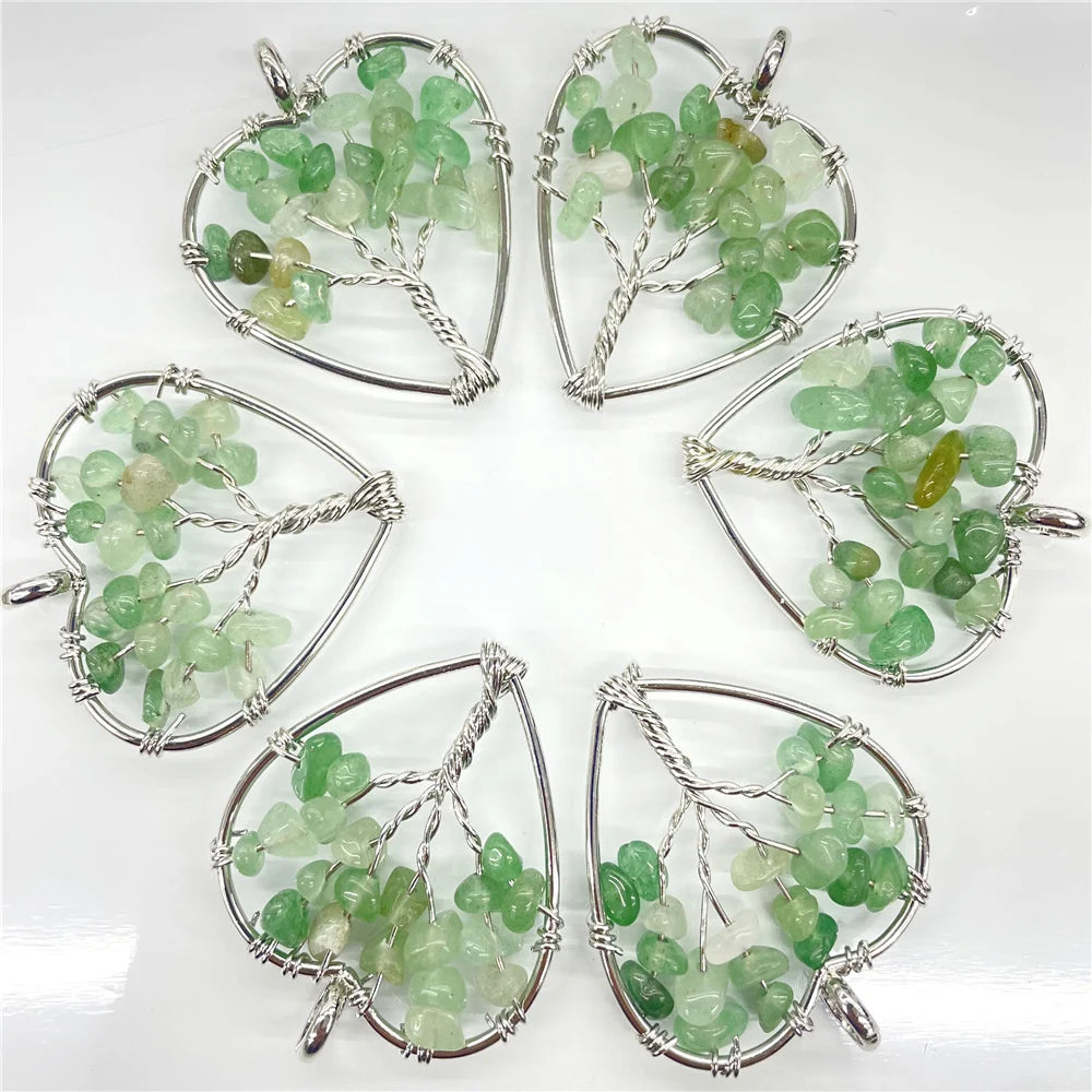 Five green gemstone pendants in silver wireframe designs on a white background