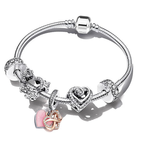 Silver bracelet with heart-shaped charm and pink heart pendant on a white background