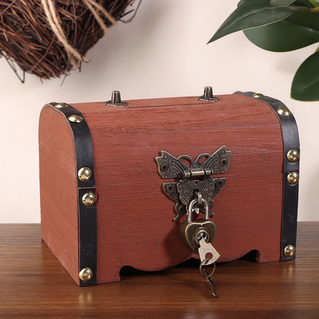 Wooden treasure chest with butterfly lock on a wooden surface