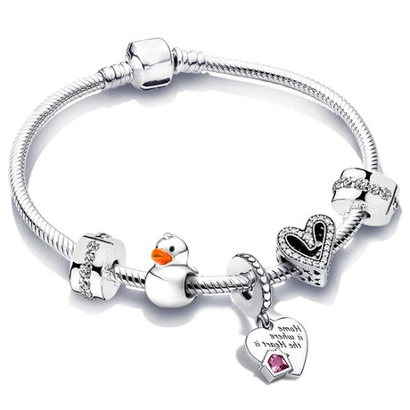 Silver bracelet with various charms including a heart, duck, and pink gemstone on a white background
