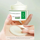 Hand holding a jar of cream with a close-up of the cream's texture on a light gray background
