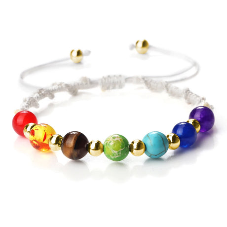 Colorful beaded bracelet with gold accents on a white background