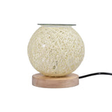 Round woven lamp with wooden base on a white background