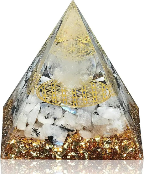 Crystal pyramid with gold accents and embedded stones on a white background