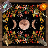 Decorative mat with moon phases, flowers, and candles on a wooden surface