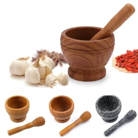 Wooden mortar and pestle set with garlic and spices on a white background