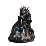 Dragon-shaped incense burner with a blue orb on a white background