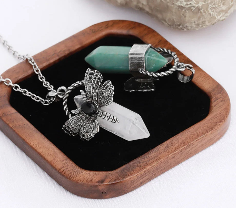 Jewelry set with butterfly pendant and crystal on a wooden stand