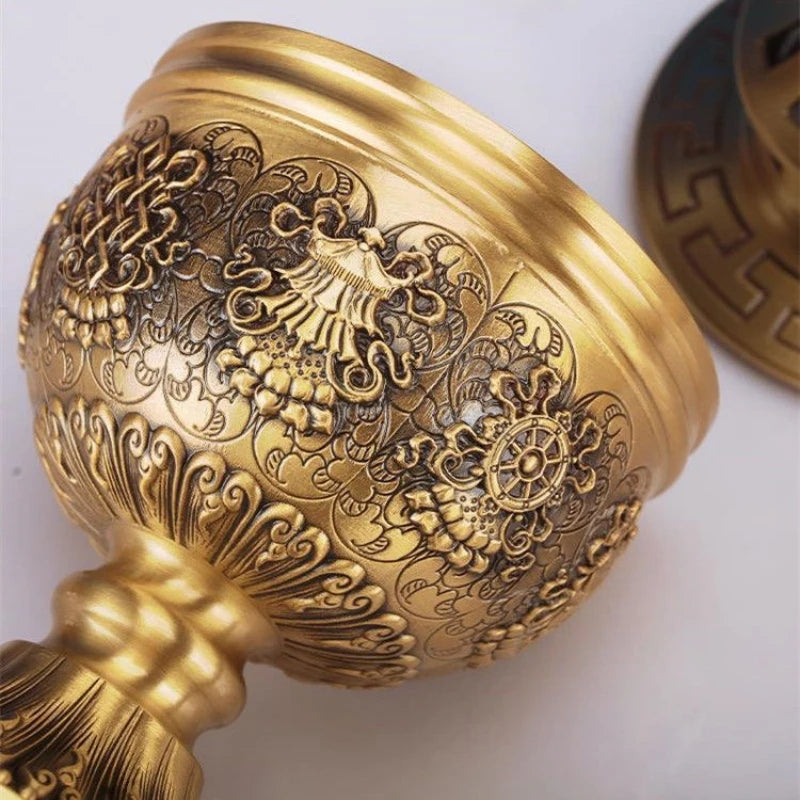 Decorative gold object with intricate patterns on a white background
