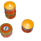 Three small candles with orange labels on a white background