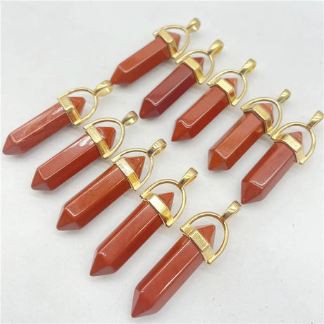 Red stone pendants with gold accents on a white background