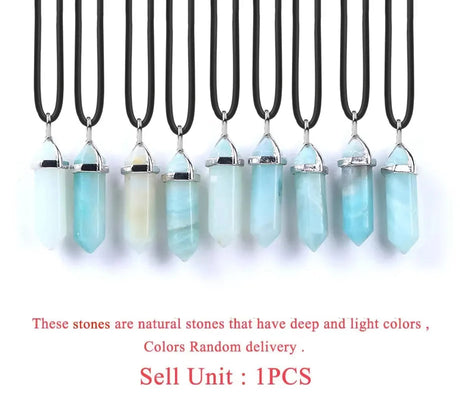 Necklaces with crystal pendants on black cords against a white background
