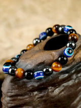 Multicolored beaded bracelet on a stone surface with a blurred natural background