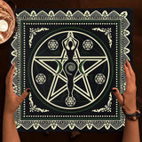 Person holding a black and white symbol poster with hands on a wooden surface.