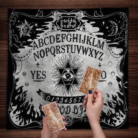 Ouija board with cards on a wooden surface