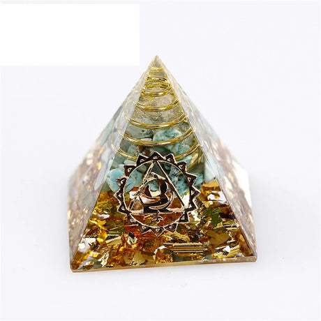 Pyramid-shaped crystal with intricate design on a white background