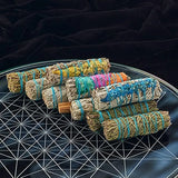 Set of smudge sticks with colorful string on a dark surface