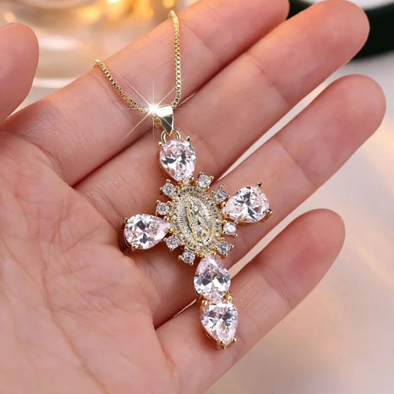 Gold necklace with a diamond pendant held in a hand against a blurred background