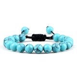 Turquoise beaded bracelet with a black cord on a white background