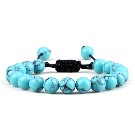 Turquoise beaded bracelet with a black cord on a white background