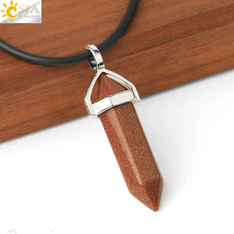 Brown stone pendant on a black cord against a wooden background