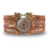 Brown leather bracelet with decorative clasp on a white background