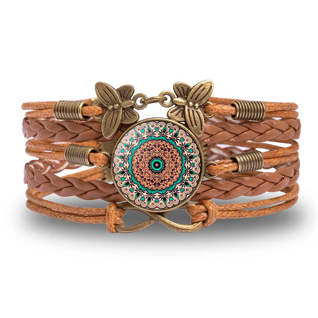 Brown leather bracelet with decorative clasp on a white background