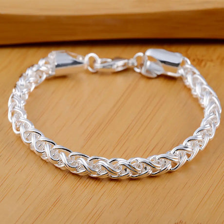 Silver braided bracelet on a wooden surface