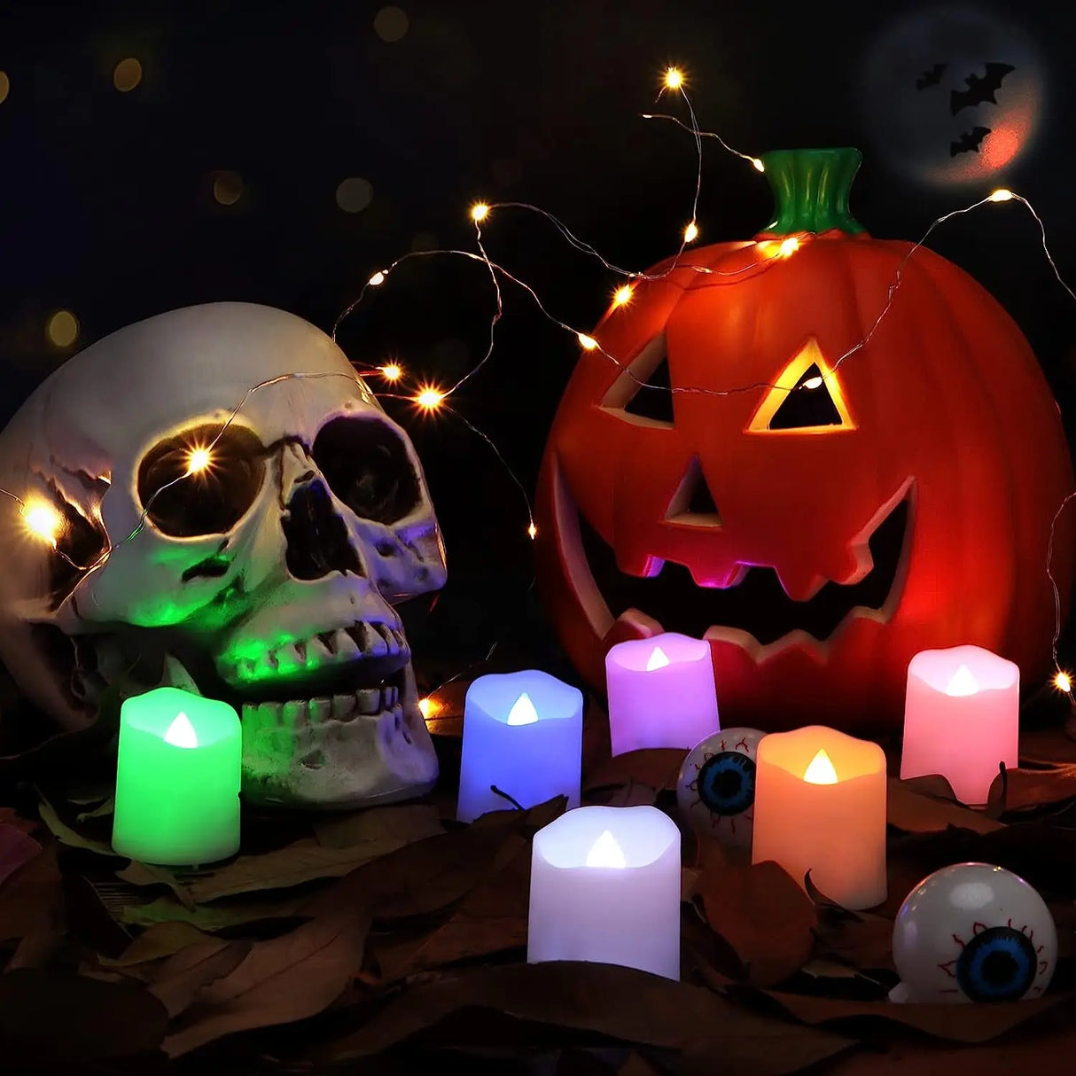 Halloween-themed decor with skull, pumpkin, candles, and string lights on a dark background.