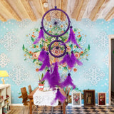 Purple dreamcatcher hanging on a wall with decorative patterns
