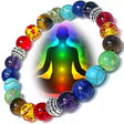 Colorful beaded bracelet with chakra colors and a silhouette of a meditating person.