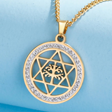 Gold necklace with a circular pendant featuring a tree design on a light blue background