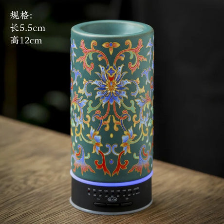 Decorative cylindrical object with floral patterns on a wooden surface