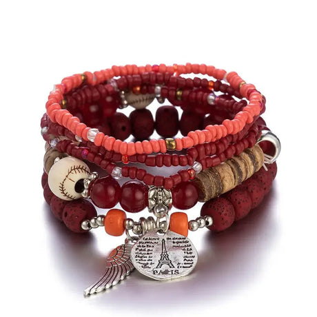 Stack of red beaded bracelets with charms on a white background