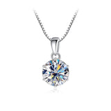 Silver necklace with a round, faceted pendant on a white background