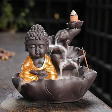 Decorative incense burner shaped like a Buddha figure with smoke rising.