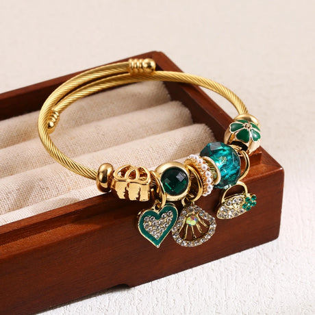 Gold bracelet with charms on a wooden display box