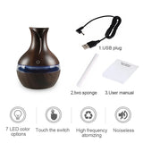 Wooden diffuser with USB cable, two sponges, and user manual on a white background