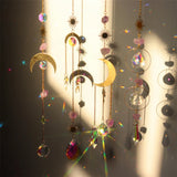 Decorative hanging elements with crystals and celestial designs on a dark background