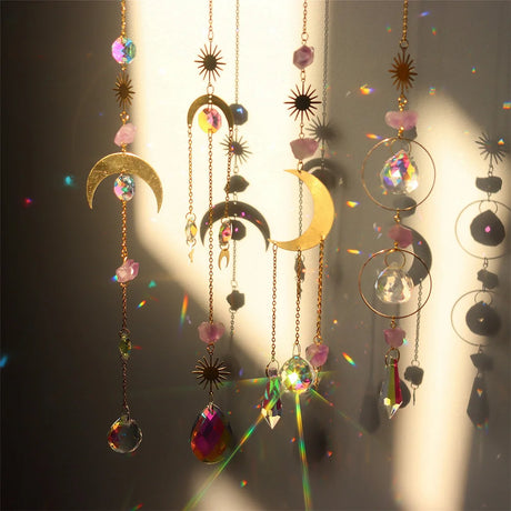Decorative hanging elements with crystals and celestial designs on a dark background