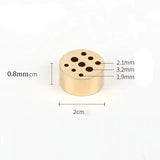 Gold-colored cylindrical object with holes and measurements on a white background