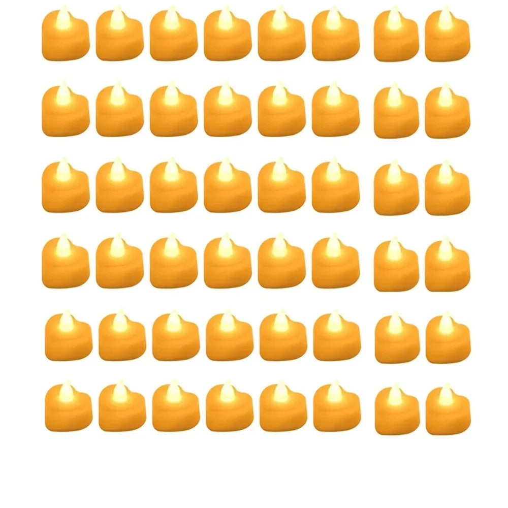 Multiple small yellow candles arranged in rows on a white background