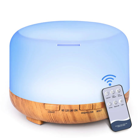 Aromatherapy diffuser with wooden base and remote control on a white background