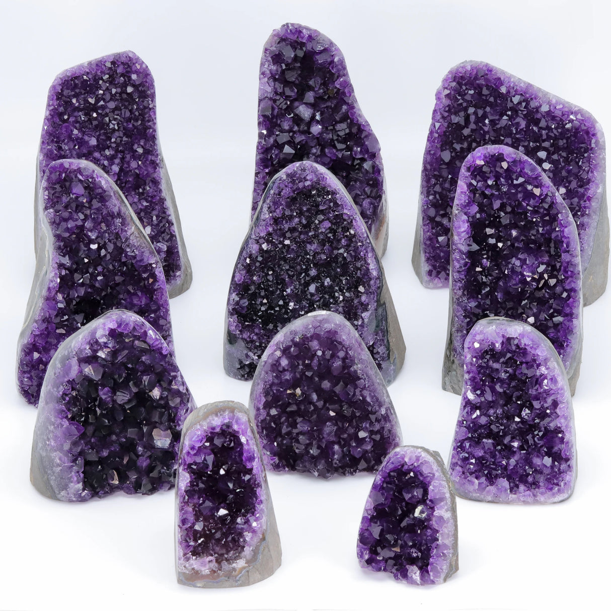 Collection of purple crystal geodes on a white background