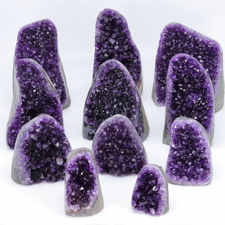 Collection of purple crystal geodes on a white background
