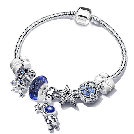 Silver bracelet with blue and clear charm beads on a white background
